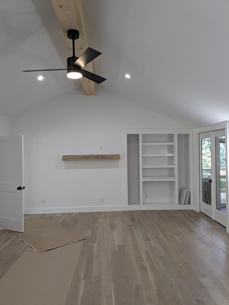 A room with white walls and wooden floors.