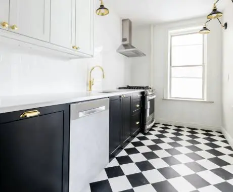 A kitchen with black and white checkered floor