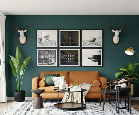 A living room with green walls and brown furniture.
