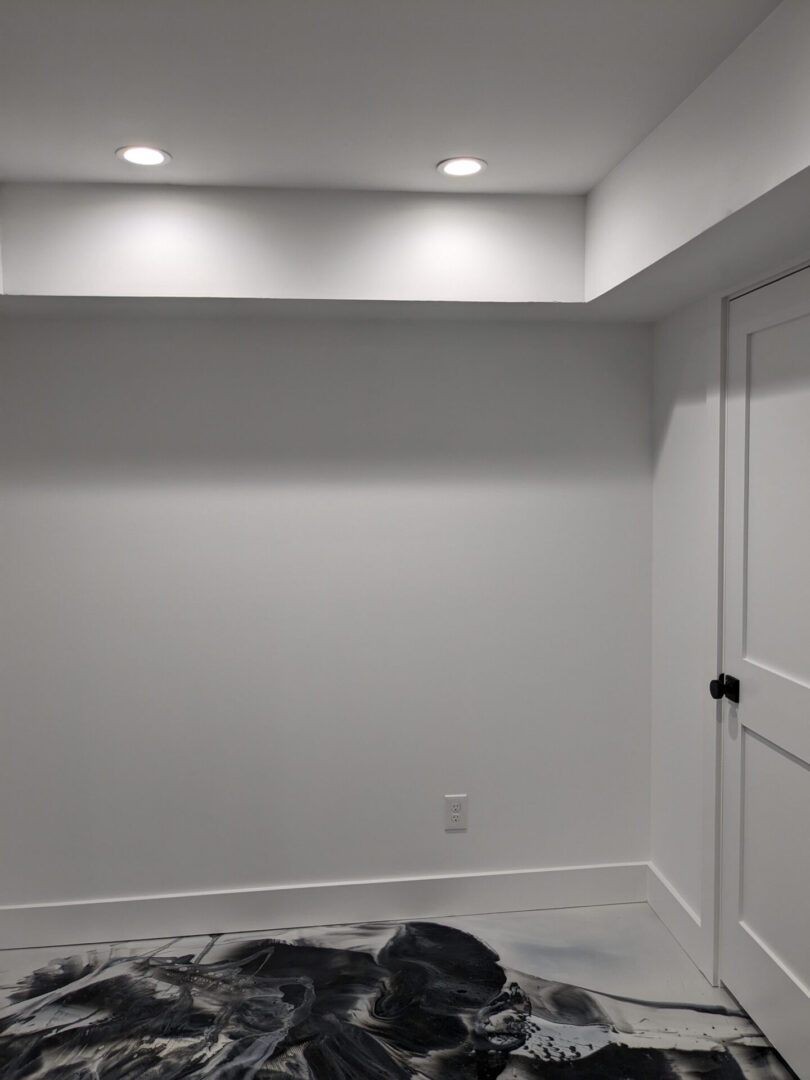 A room with white walls and a door.