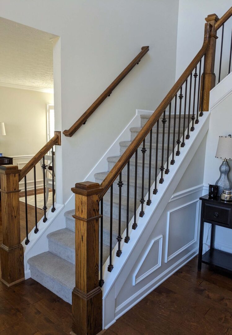 A staircase with wood and metal railing.