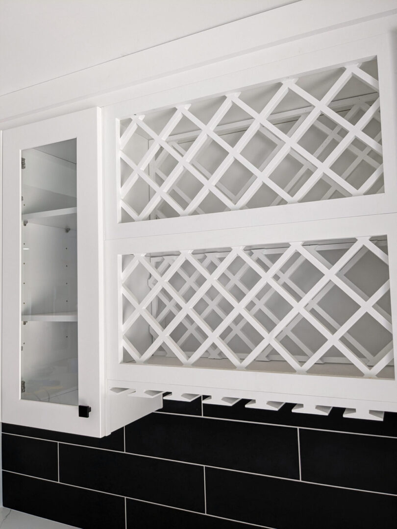 A white cabinet with glass doors and shelves.